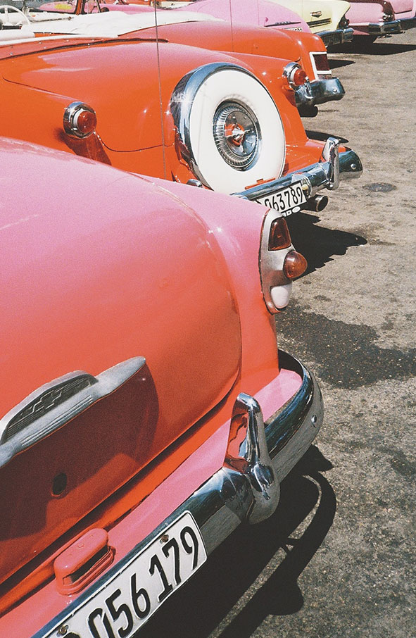 Row of red and pink cars in Havana, Cuba